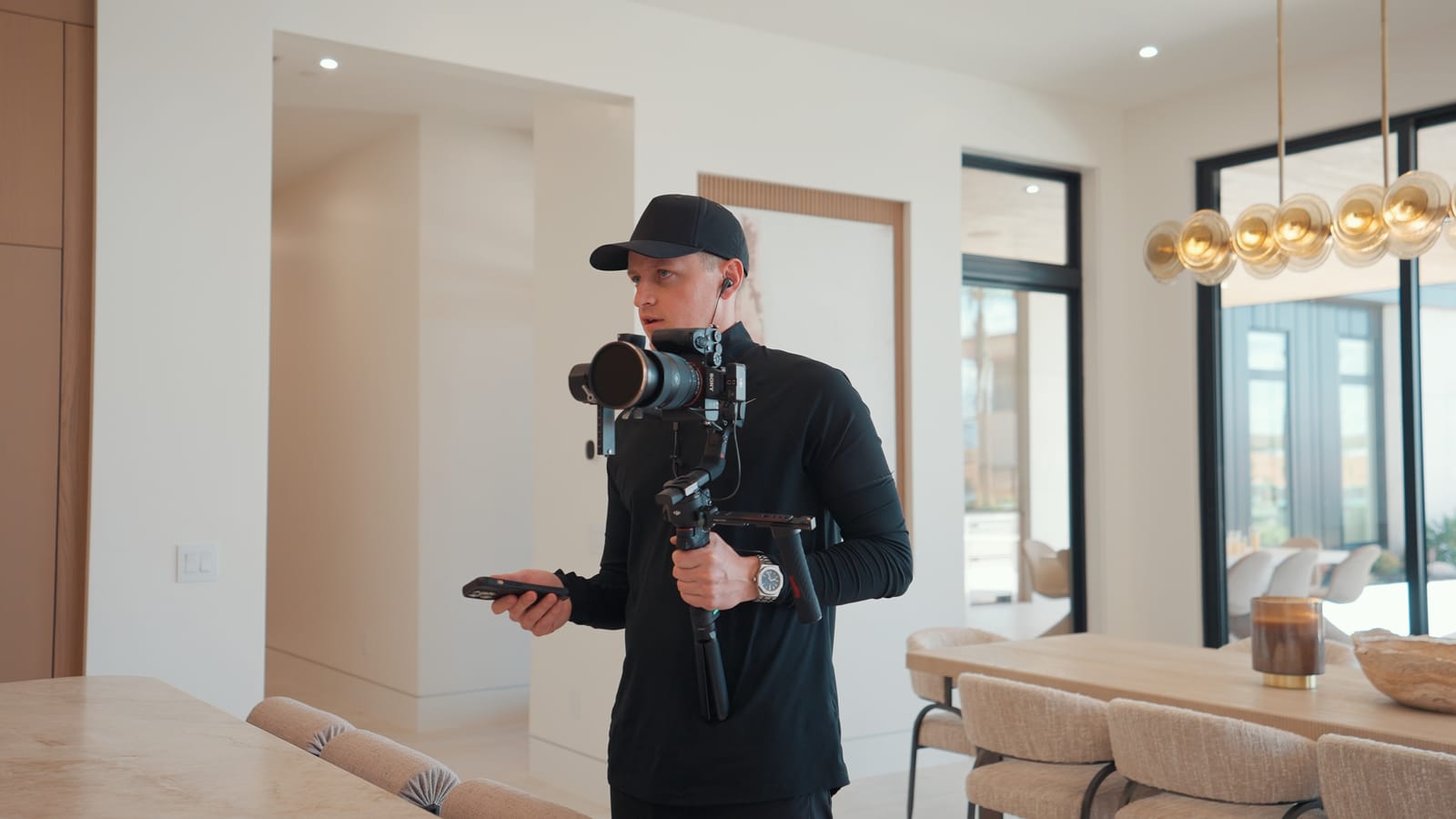 JT filming inside a bright modern home